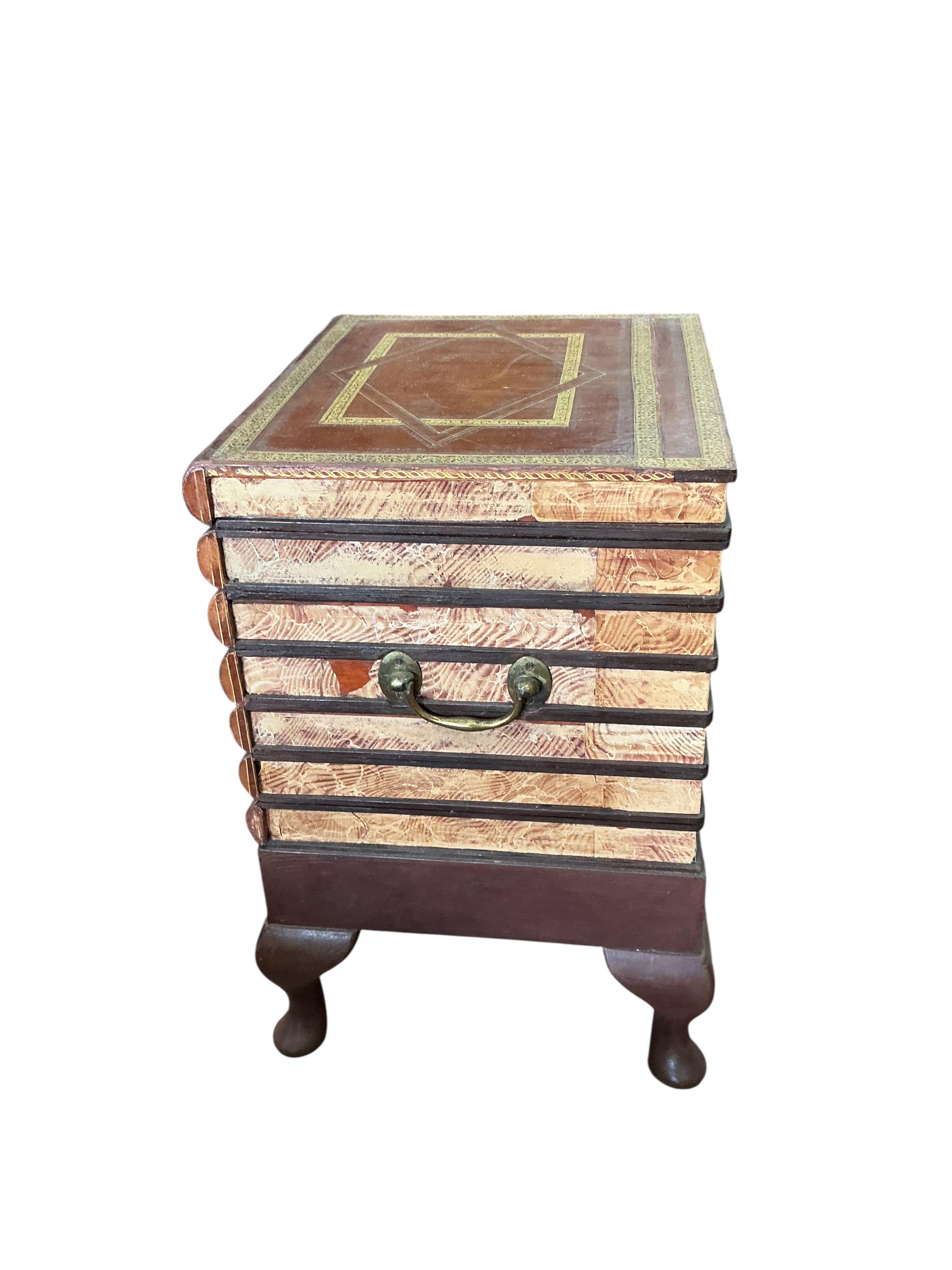 A reproduction cellarette modelled as a stack of antiquarian books, width 42cm, depth 37cm, height 58cm